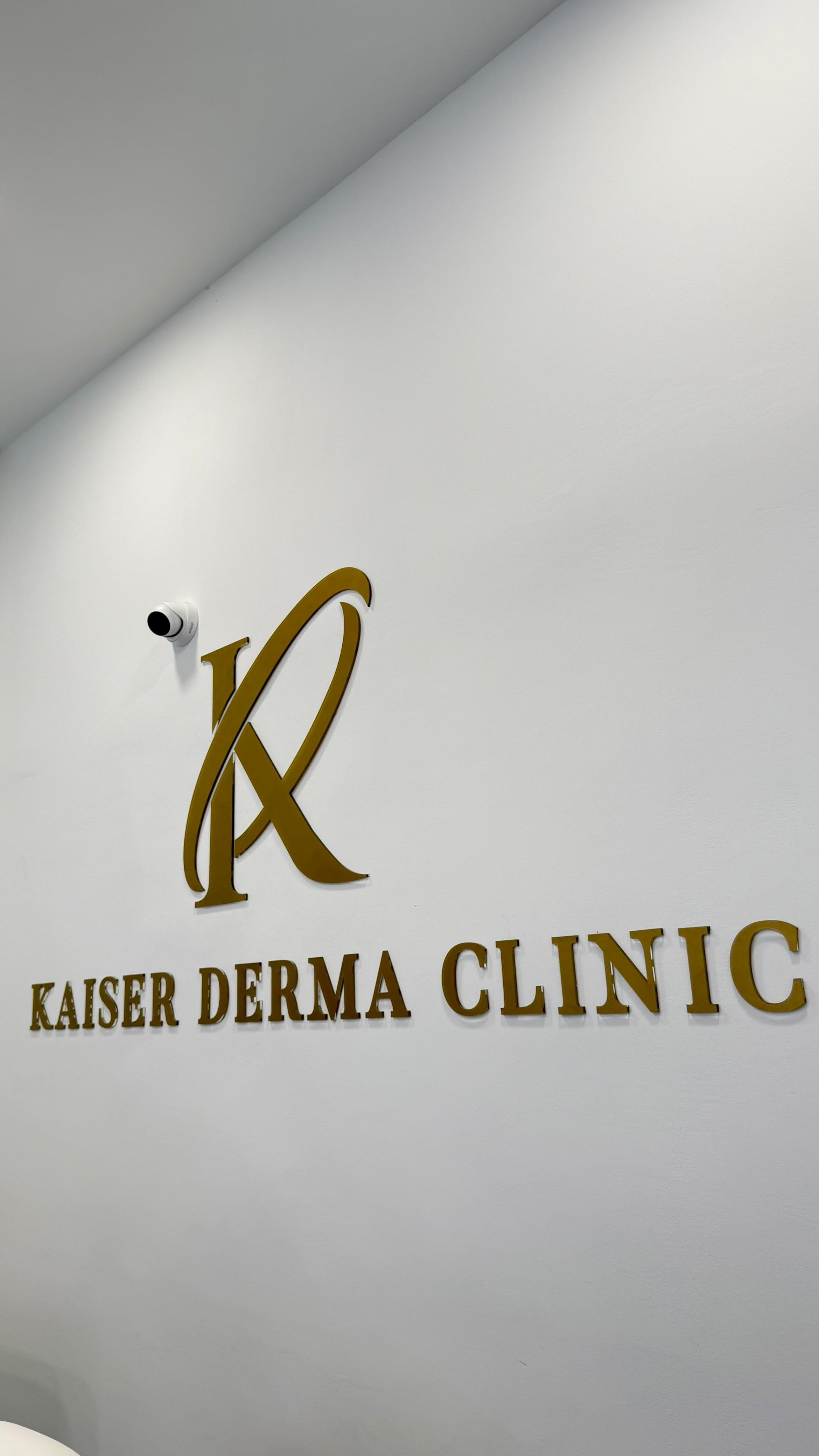 Kaiser Derma Clinic — gold monogram wall sign